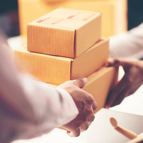 People with hands on boxes